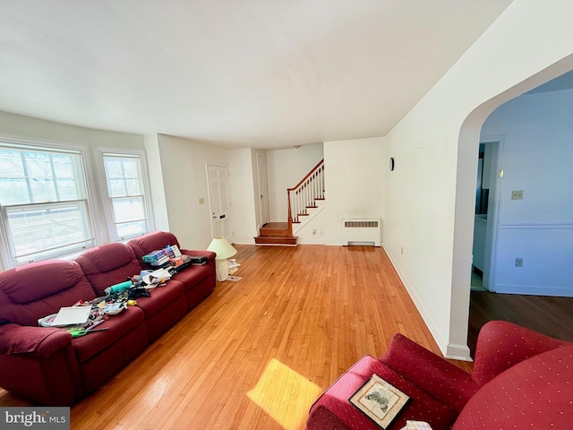 living room with hardwood / wood-style floors and radiator heating unit