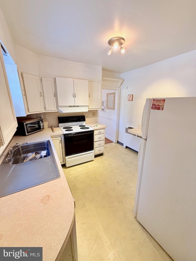 kitchen with sink, white cabinets, and white appliances