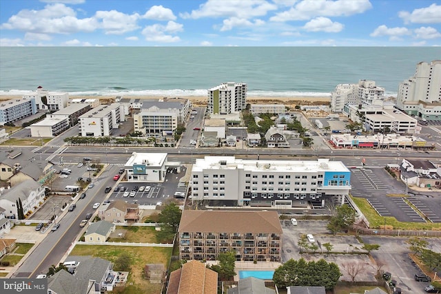 birds eye view of property with a water view and a view of the beach