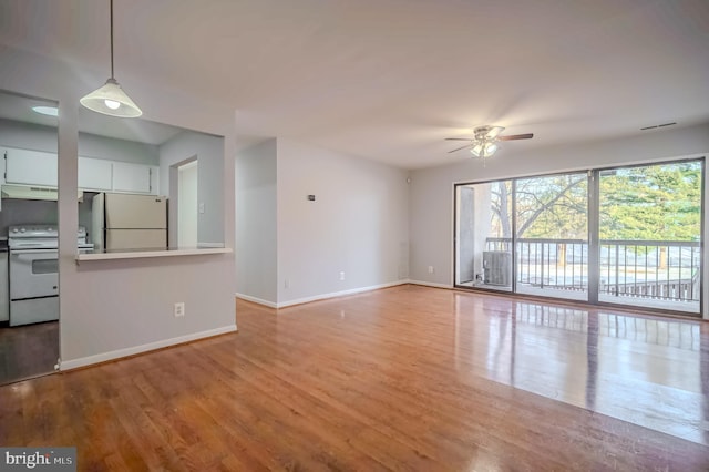 unfurnished living room featuring ceiling fan and light wood-type flooring