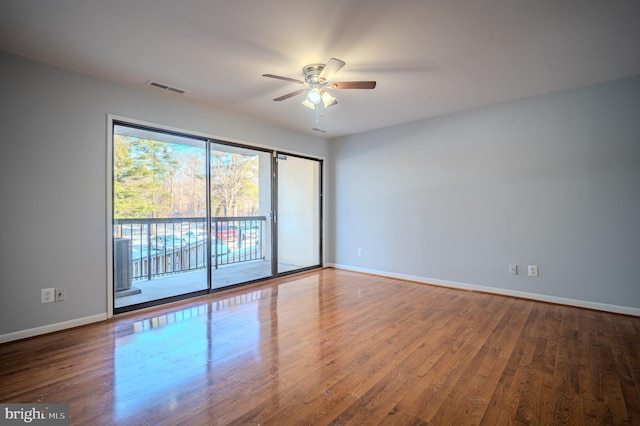 empty room with hardwood / wood-style flooring and ceiling fan