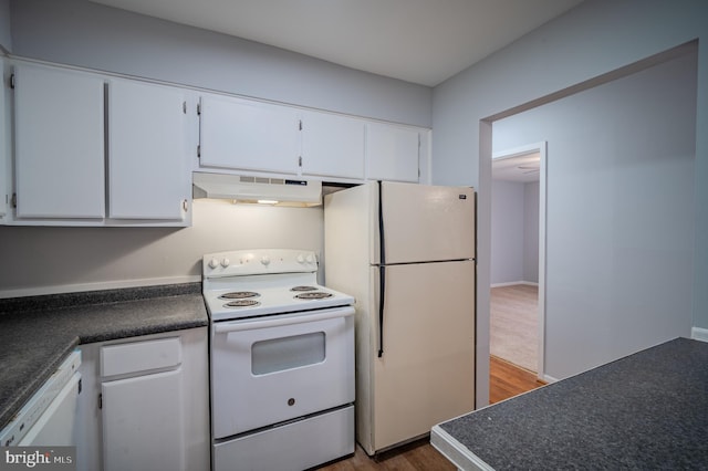 kitchen with hardwood / wood-style floors, white appliances, and white cabinetry