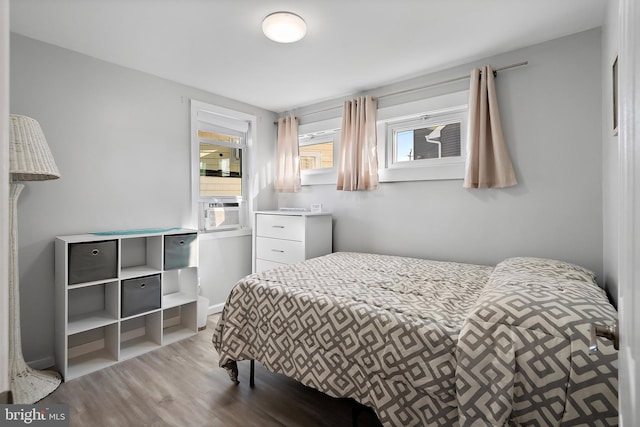 bedroom featuring light hardwood / wood-style flooring and cooling unit