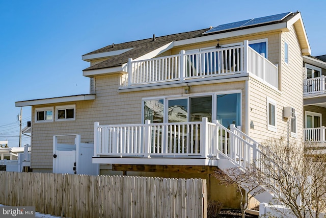 back of property with a balcony