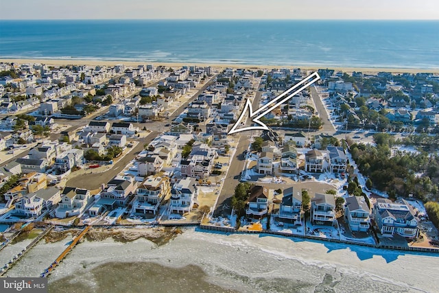 drone / aerial view featuring a beach view and a water view