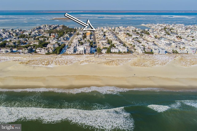 bird's eye view featuring a view of the beach and a water view