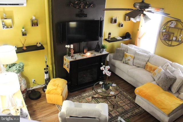 living room featuring an AC wall unit, ceiling fan, and dark hardwood / wood-style flooring