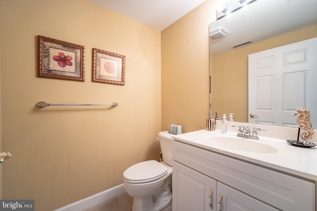 bathroom with tile patterned floors, vanity, and toilet