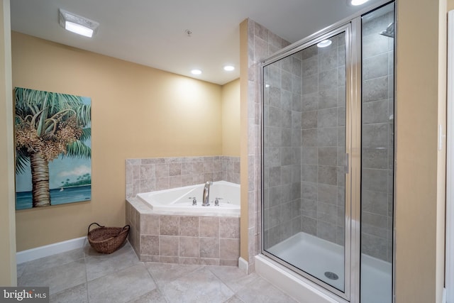 bathroom with separate shower and tub and tile patterned flooring