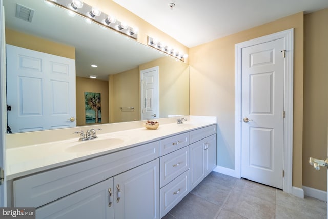 bathroom featuring tile patterned flooring and vanity