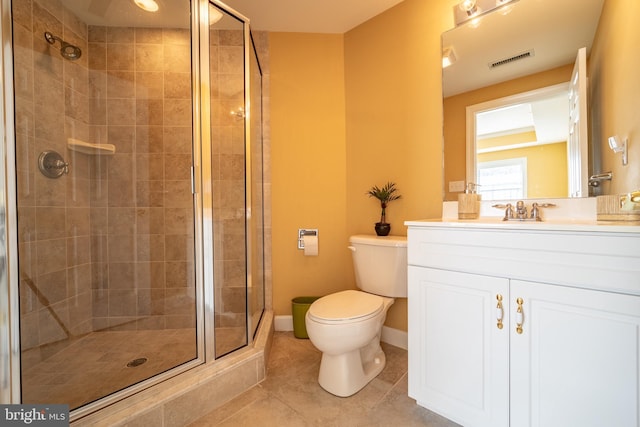 bathroom with toilet, vanity, tile patterned floors, and a shower with door