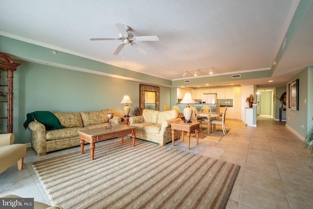 living room with ceiling fan, light tile patterned floors, ornamental molding, and track lighting