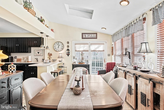 dining room with vaulted ceiling