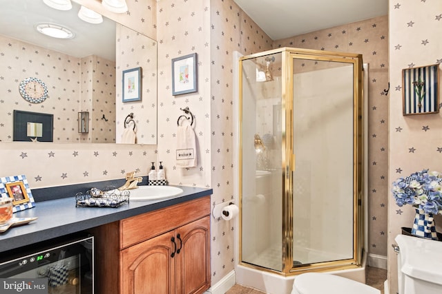 bathroom with tile patterned floors, toilet, a shower with shower door, vanity, and beverage cooler