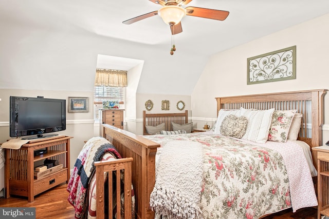 bedroom with dark wood-type flooring, ceiling fan, and lofted ceiling