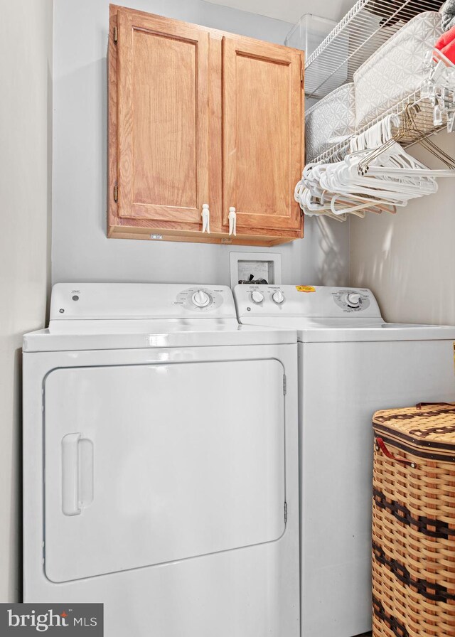 laundry area with cabinets and washer and dryer