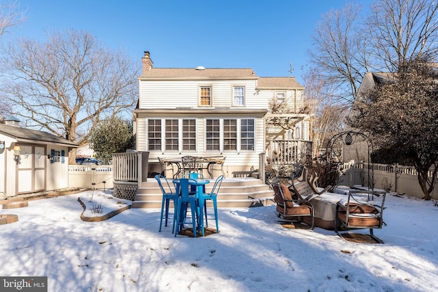 snow covered property featuring a deck