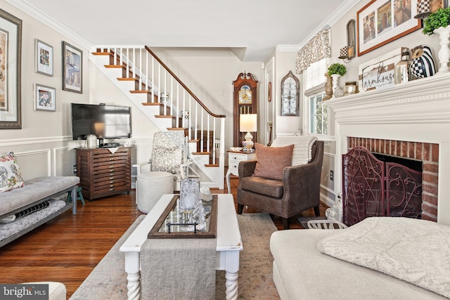 living room featuring crown molding, dark wood-type flooring, and a fireplace