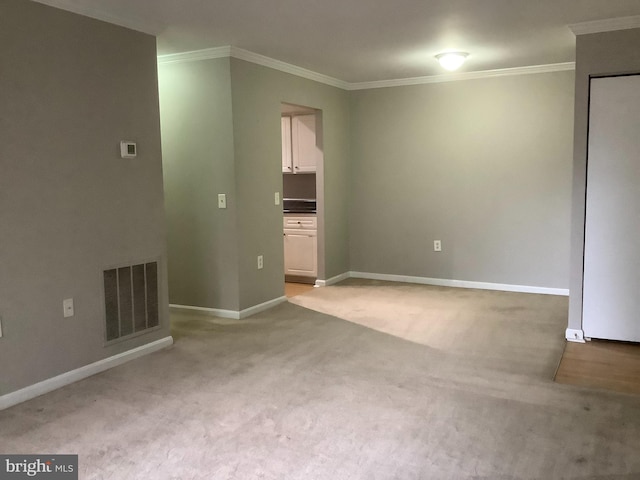 carpeted spare room with crown molding