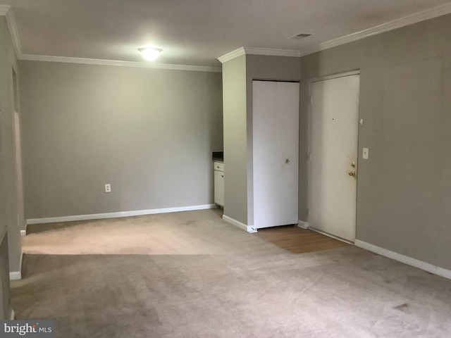 unfurnished bedroom with light colored carpet and crown molding