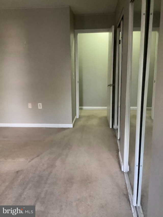 hallway featuring light carpet