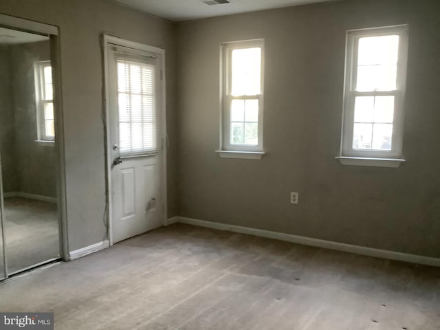 doorway with light colored carpet