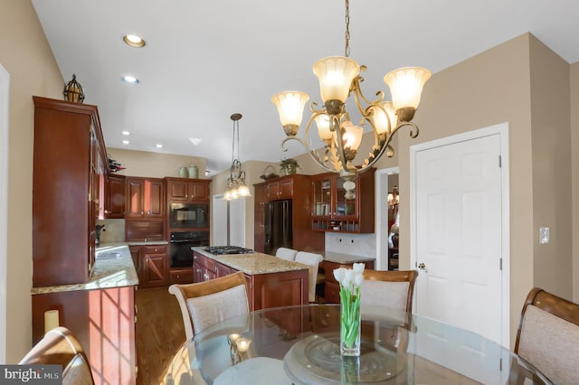 dining area with dark hardwood / wood-style floors, sink, and a notable chandelier