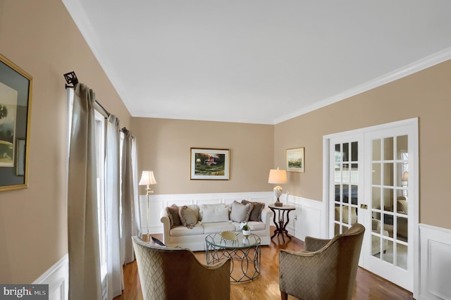 living room featuring hardwood / wood-style flooring, ornamental molding, and french doors