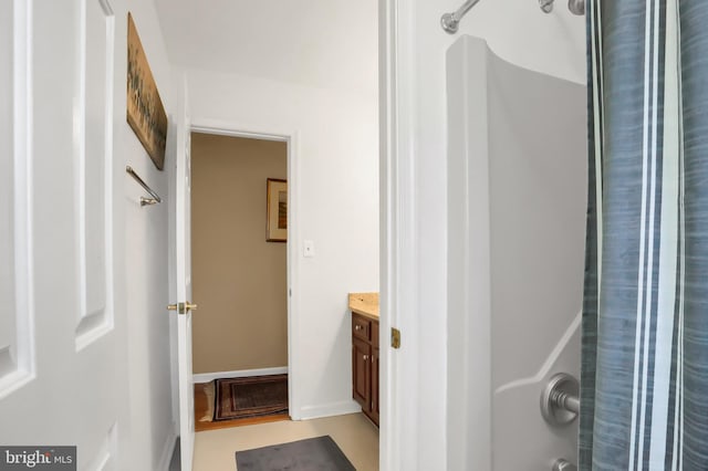 bathroom with walk in shower and vanity