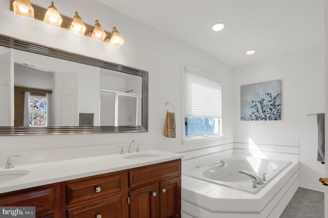 bathroom with vanity and shower with separate bathtub