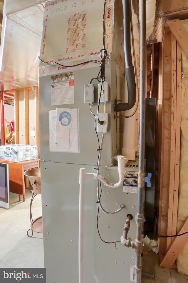 utility room featuring heating unit