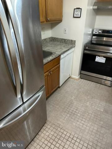 kitchen featuring stainless steel appliances, sink, stone counters, and ventilation hood