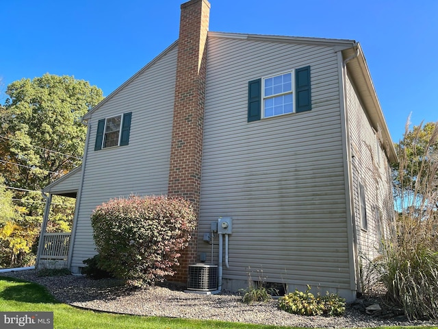 view of side of home featuring central AC unit