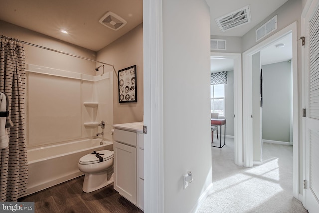 full bathroom featuring toilet, shower / tub combo, hardwood / wood-style floors, and vanity