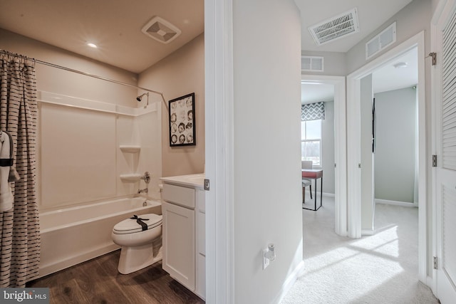 full bathroom featuring toilet, wood-type flooring, vanity, and shower / bath combo with shower curtain