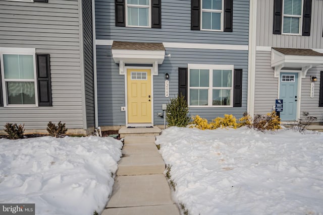 view of snow covered property entrance