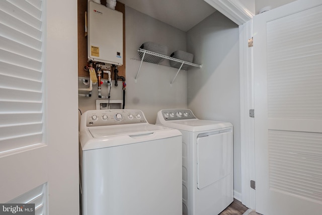 laundry room featuring water heater and washing machine and clothes dryer