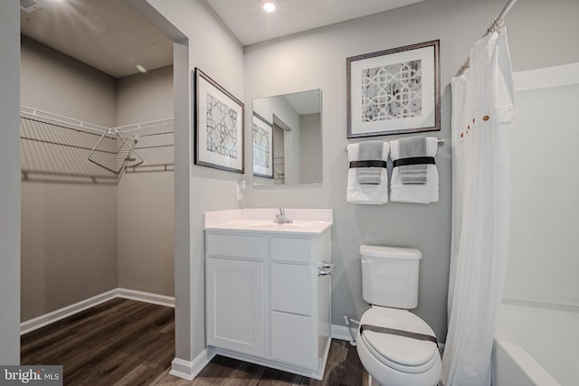 full bathroom featuring toilet, shower / bath combo with shower curtain, vanity, and hardwood / wood-style floors