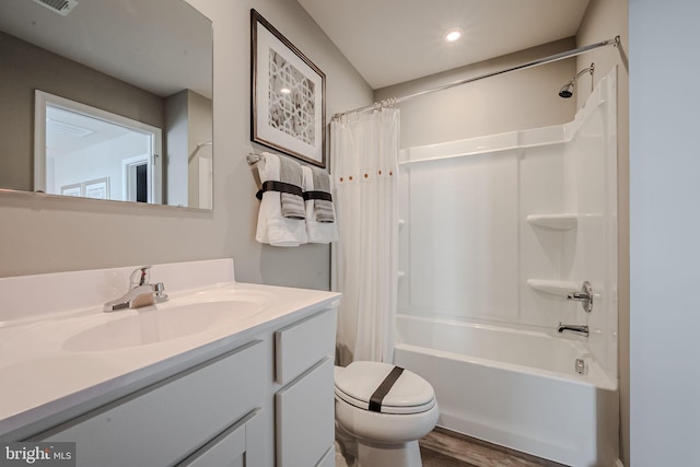 full bathroom with toilet, hardwood / wood-style flooring, shower / bath combo with shower curtain, and vanity