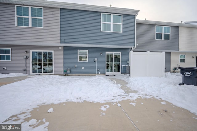 view of snow covered rear of property