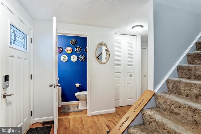 interior space featuring hardwood / wood-style flooring and a textured ceiling