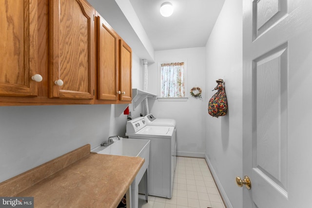 clothes washing area with cabinets, separate washer and dryer, and sink