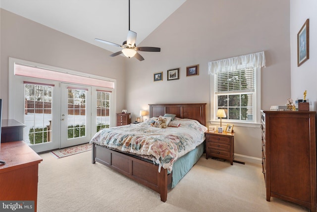 carpeted bedroom with ceiling fan, access to exterior, high vaulted ceiling, and french doors