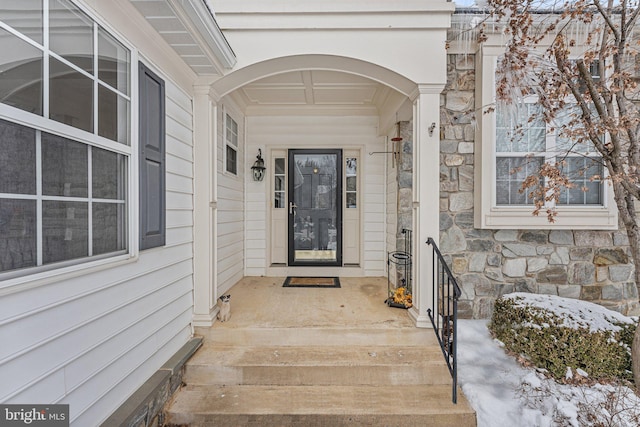 view of snow covered property entrance