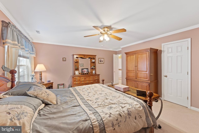 carpeted bedroom with ceiling fan and ornamental molding