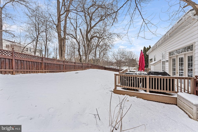 snowy yard featuring a wooden deck