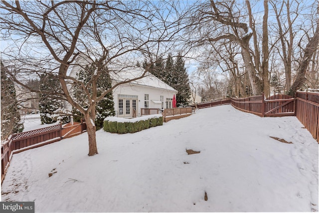 snowy yard with french doors