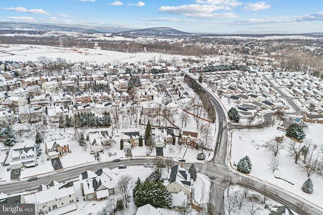 snowy aerial view with a mountain view