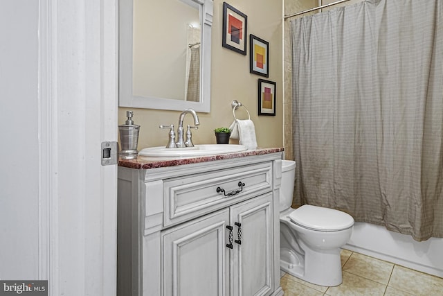 full bathroom with shower / bathtub combination with curtain, vanity, tile patterned floors, and toilet