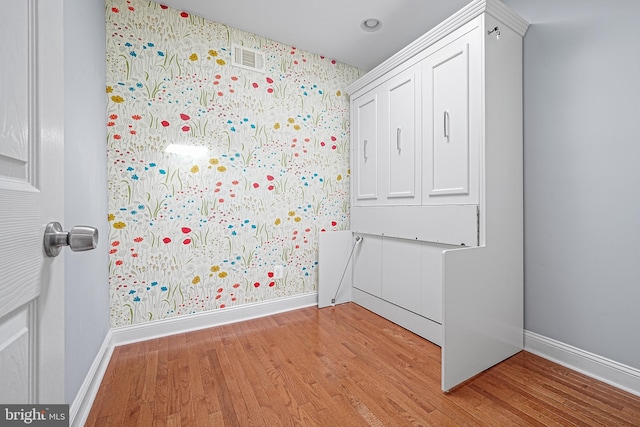 unfurnished bedroom with light wood-type flooring